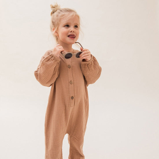 This Claude & Co jumpsuit with collar in Fawn is the perfect gender neutral piece for your little ones wardrobe. 
